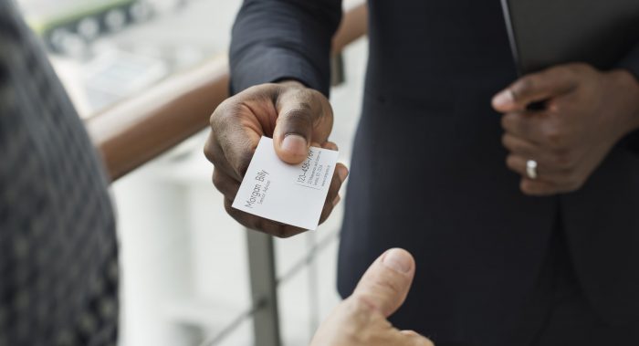 person passing out business cards